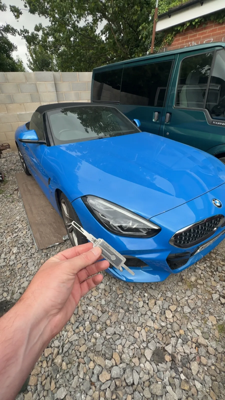 New BMW Z4 remote key held in front of a blue BMW Z4 in Derby