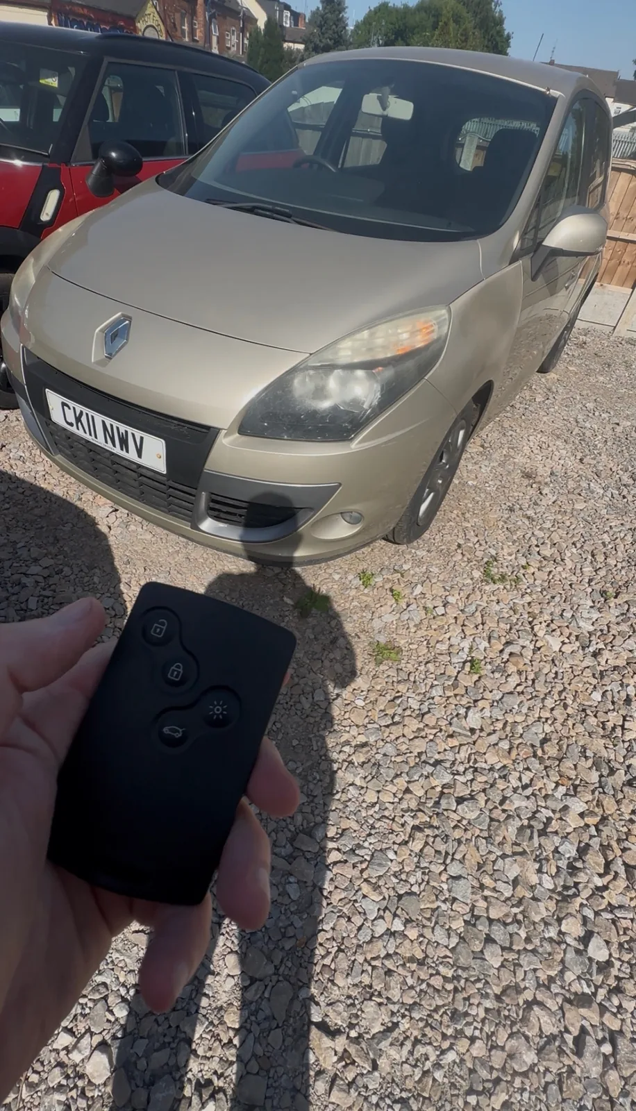 Renault Scenic remote card key held in front of the vehicle after programming
